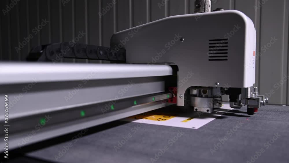 Close-up shallow depth of field a production plotter at a printing house automatically cuts packaging and labels from cardboard
