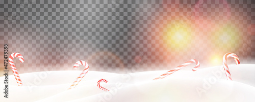 Christmas candy canes on snowy background.