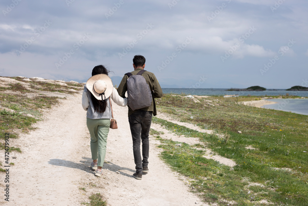 traveler couple walking near lake