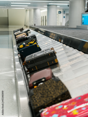 Suitcases on conveyer belt in baggage claim