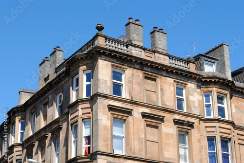 Classical Old Victorian 19th Century Residential Building seen from Below against Blue Sky