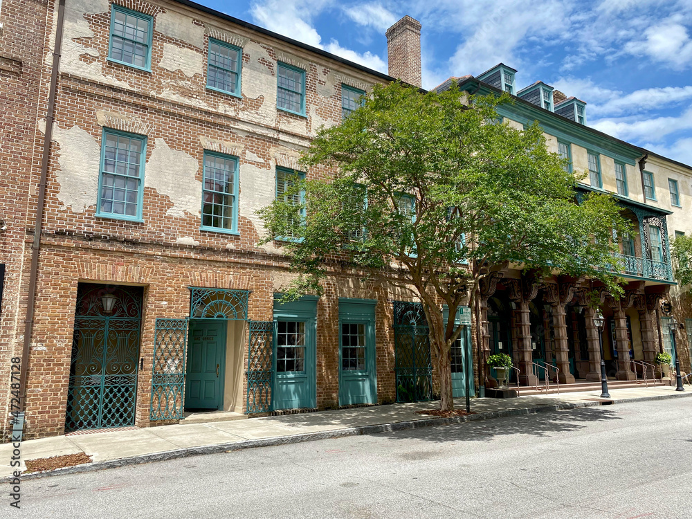 Charleston, South Carolina, USA: Dock Street Theatre in the historic downtown French Quarter. Brick with wrought iron balcony and sandstone columns. America’s first theater.