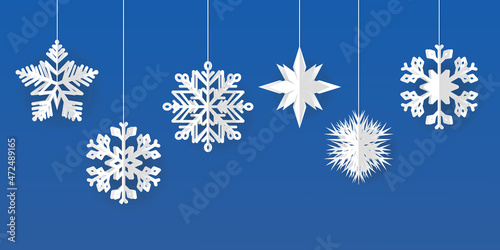 Vector set of white Christmas paper cut 3d snowflakes with shadow on a blue background. New Year and Christmas design elements