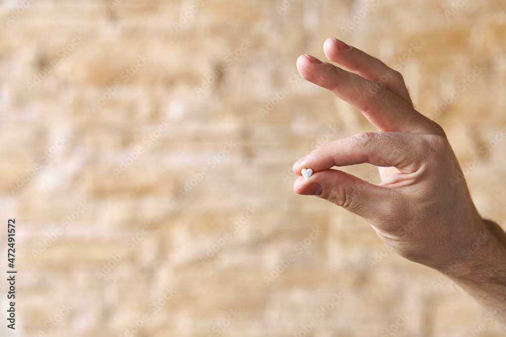 Heartache medicine. Pill in shape of heart against heart pain Heartache medicine. Pill in shape of heart against heart pain