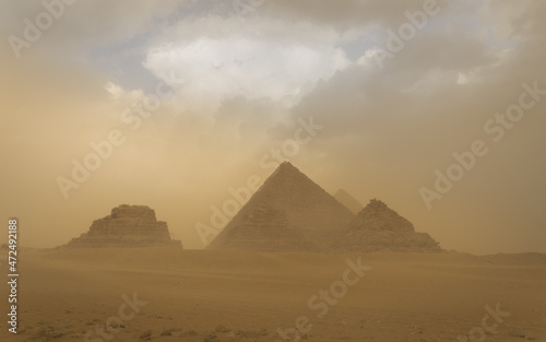 Panoramic view of the pyramids of Gizah in Cairo, Egypt, during a sandstorm. © kike cuadrado