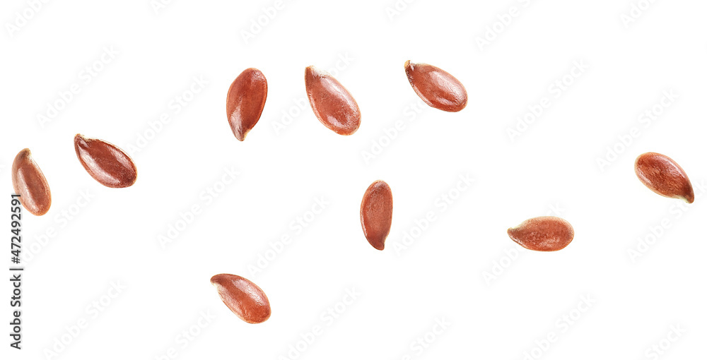 Brown flax seeds isolated on a white background, top view. Macro. Brown flax seeds isolated on a white background, top view. Macro.