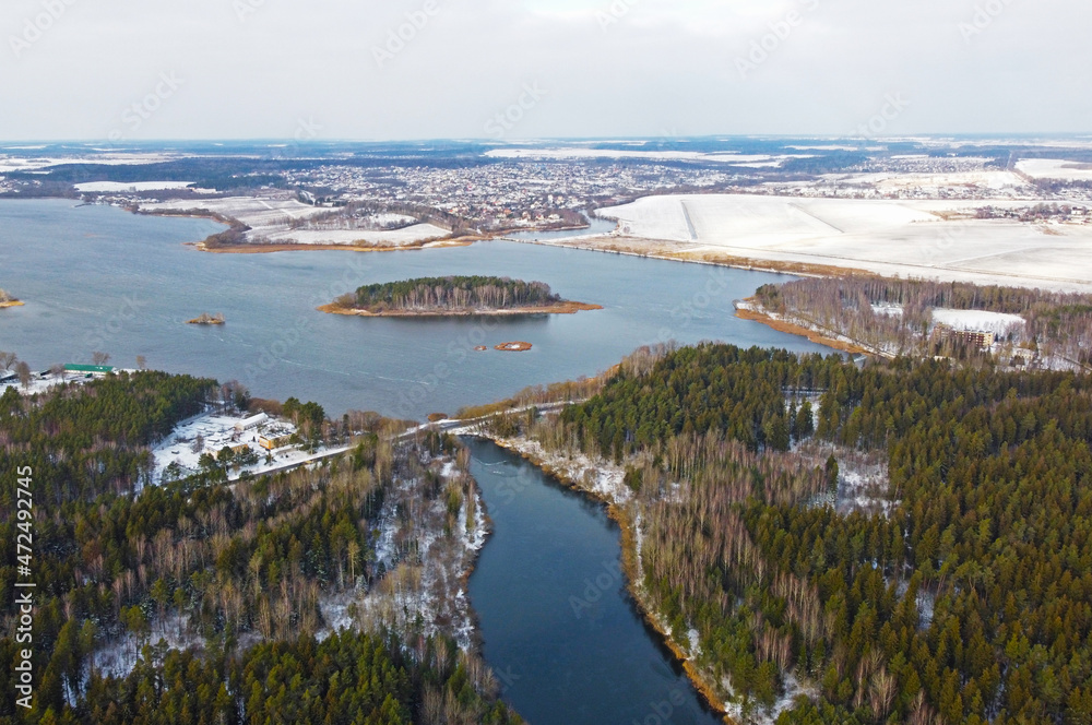 Aerial view of the blue river and green forest. Beautiful nature landscape in winter