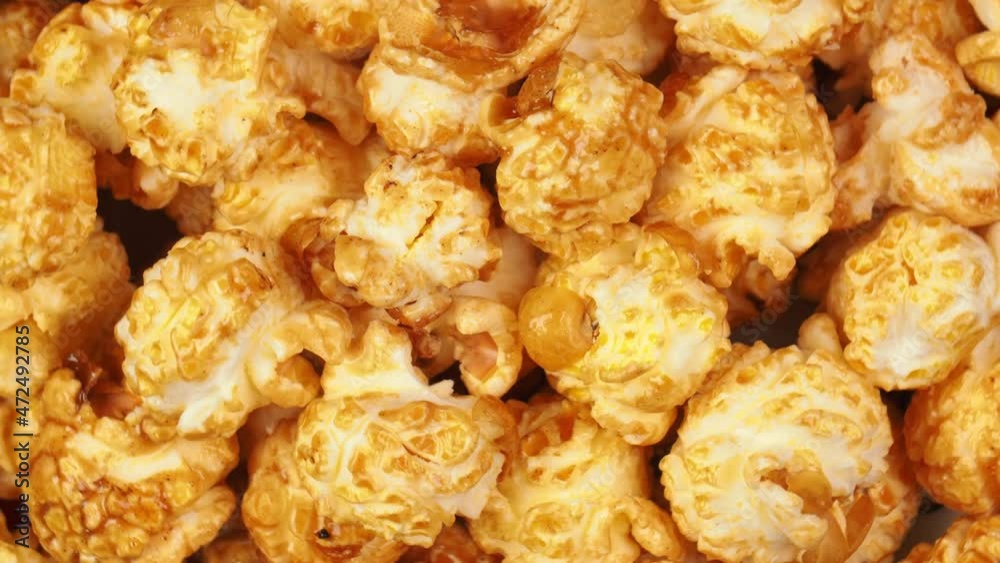 Food background of crispy popcorn with caramel spinning on its axis Food background of crispy popcorn with caramel spinning on its axis