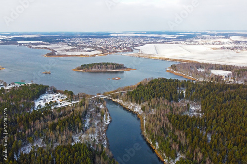 Aerial view of the blue river and green forest. Beautiful nature landscape in winter