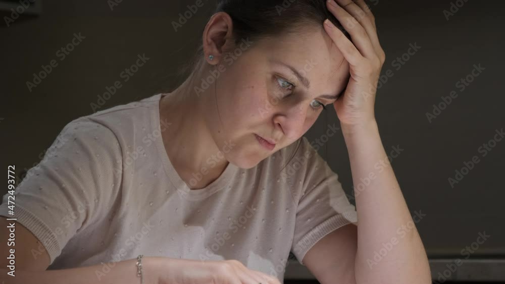 Portrait of stessed woman feeling frustrated while reading documents of divorce. Concept of financial difficulties, bankruptcy, taxes and rent payment. Portrait of stessed woman feeling frustrated while reading documents of divorce. Concept of financial difficulties, bankruptcy, taxes and rent payment.