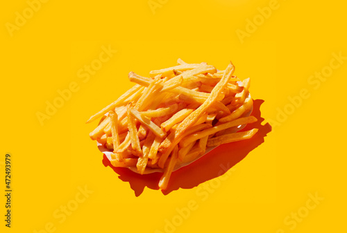 French fries on yellow pastel background