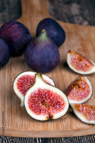 ripe purple figs on a wooden table
