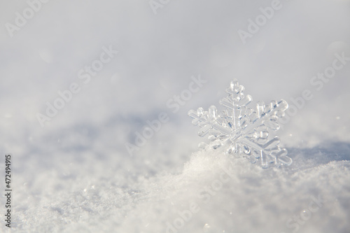 Big snowflake. Smooth surface of clean fresh snow. Snowy ground. Winter background with snow patterns. Natural snow texture.