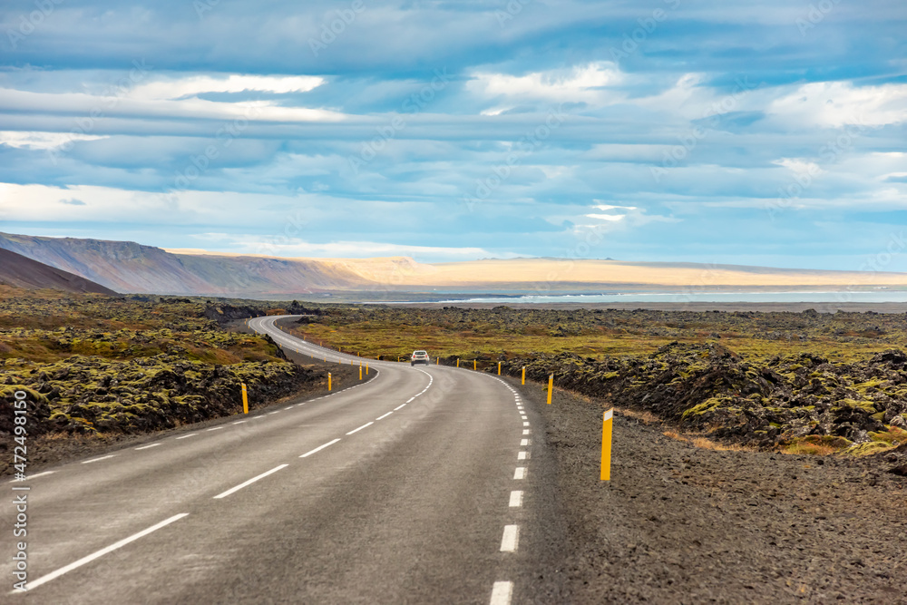 Iceland road landscape with clouds and emply field