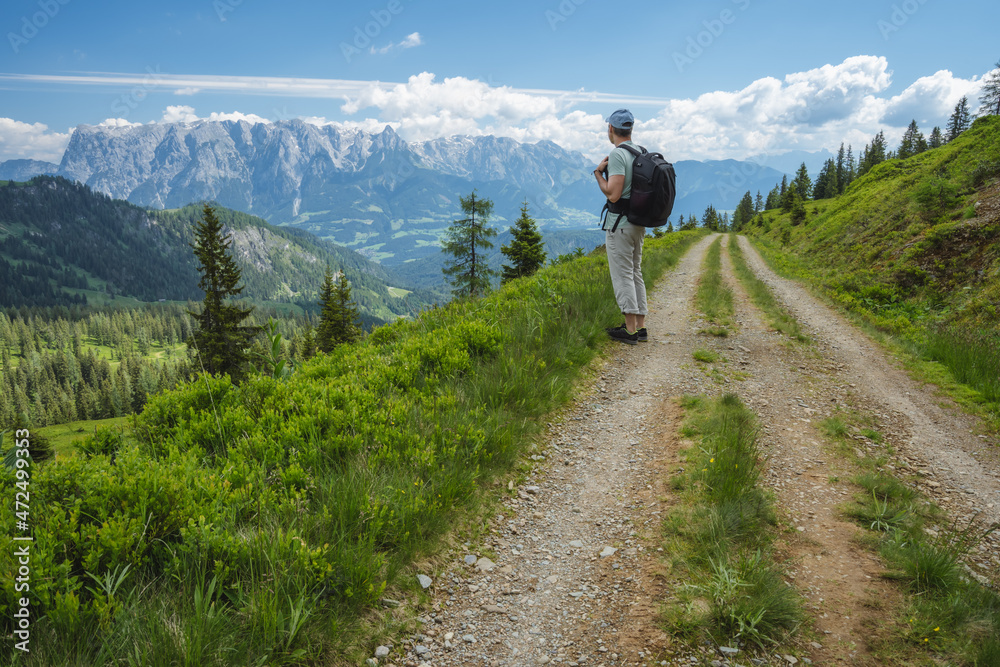 Traveler man on hiking trail enjoying Wilder Kaiser mountains, Tirol - Austria