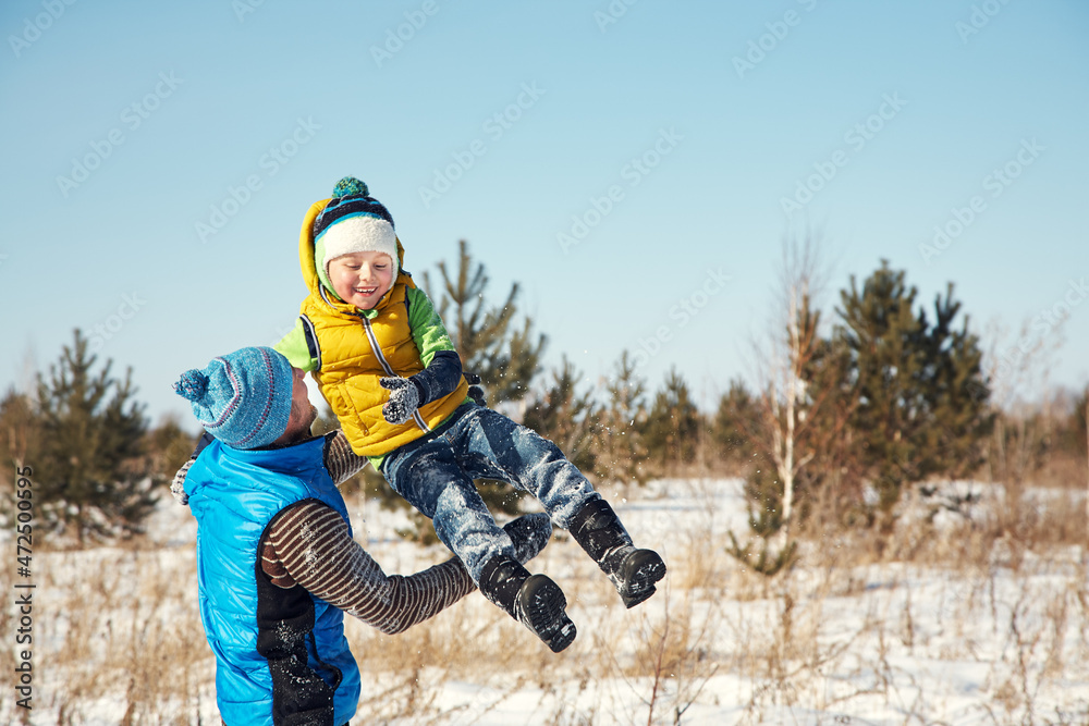 playing father and son in the winter outdoors playing father and son in the winter outdoors