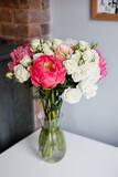 Peonies and roses in a vase