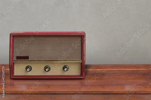 front view Ancient red turntables on wooden floor, grey wall background, object, copy space