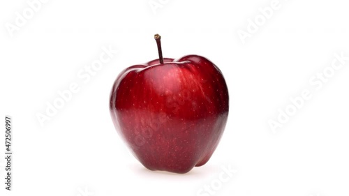 Whole red apple fruit isolated. Rotating on white background. Closeup.