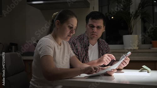 Stressed couple having no money to pay taxes, monthly payment or house loan. Concept of financial difficulties, poverty, bankruptcy, taxes and rent payment.