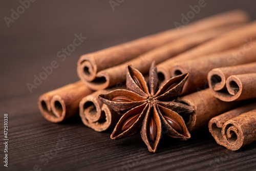 Beautiful composition of cinnamon and star anise against dark wooden background. Fresh aromatic spices