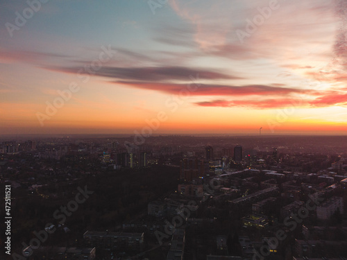 Aerial scenic vivid sunset view with epic skyscape. Kharkiv city center, Pavlove pole residential district streets in evening light