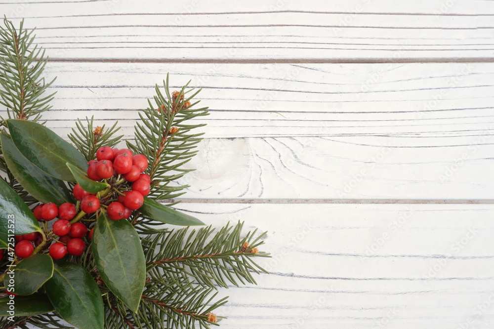 Evergreen Sprigs with Red Berries on Lower Right Corner of White Planks
