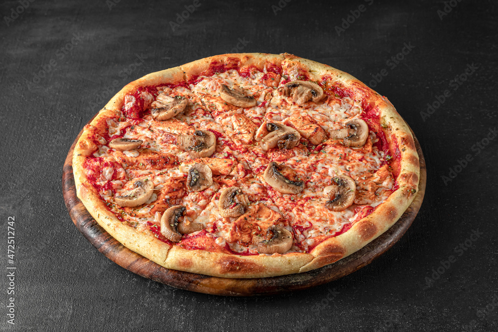 Pizza on a fluffy dough on a black background