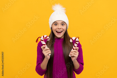 amazed teen girl wear hat hold candy stick, christmas © Olena