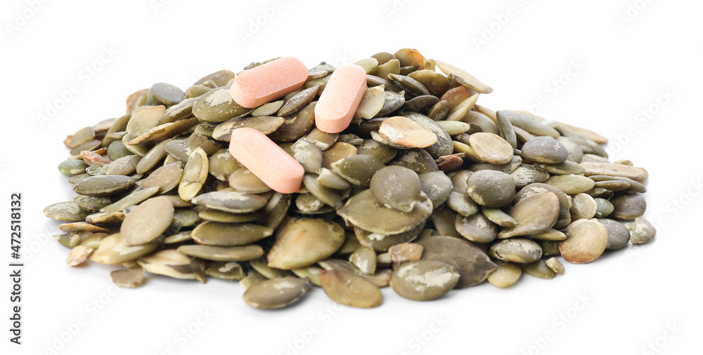 Pumpkin seeds and pills on white background Pumpkin seeds and pills on white background