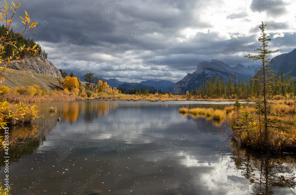 Fototapeta premium clouds reflecting on a mountain lake in autumn