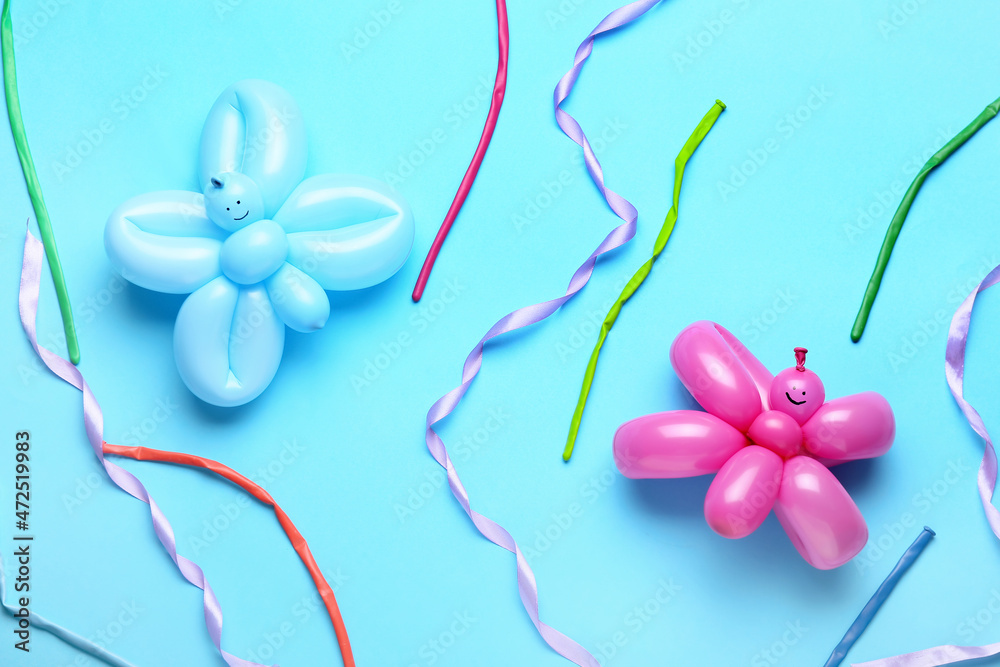 Fototapeta premium Butterflies made of balloons and ribbons on blue background