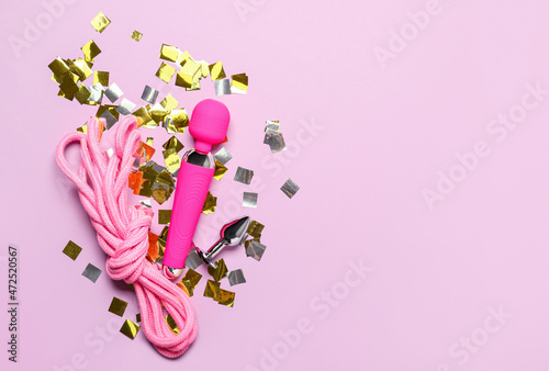 Toys from sex shop on color background