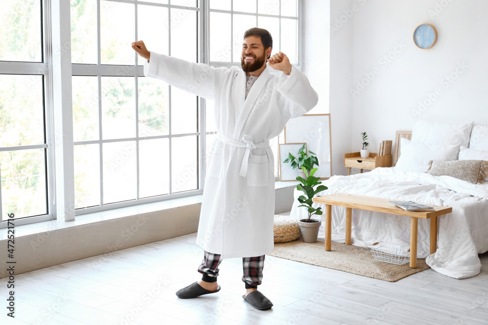 Handsome man in bathrobe dancing at home Handsome man in bathrobe dancing at home