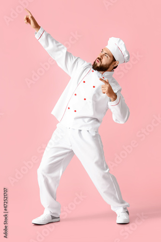 Dancing male chef on pink b...