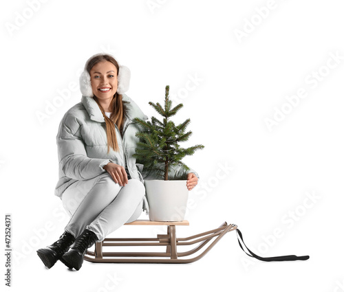 Young woman with sled and C...