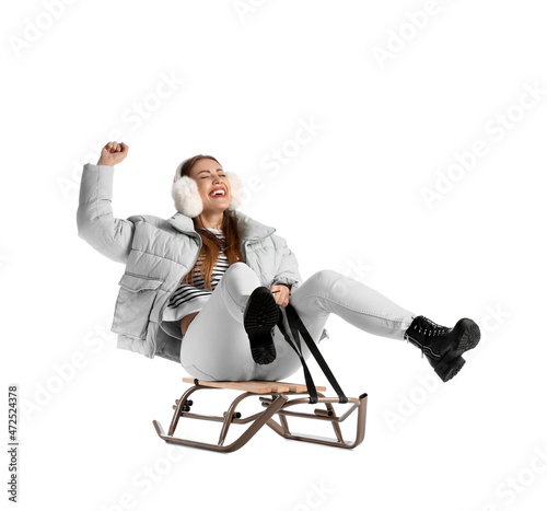 Young sledding woman on whi...