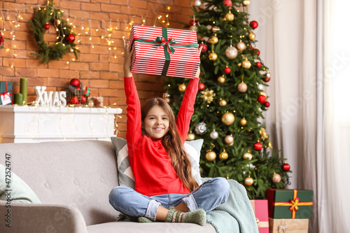 Happy little girl with gift...
