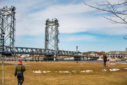 People wlak with the Memorial Bridge on the background during the winter. Portsmouth NH photo