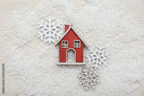 Christmas decorations and snow on light wooden background