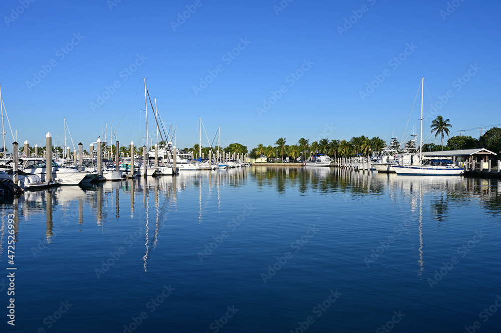 Boats docked in marina in Key Biscayne, Florida in early morning light on clear autumn day.
