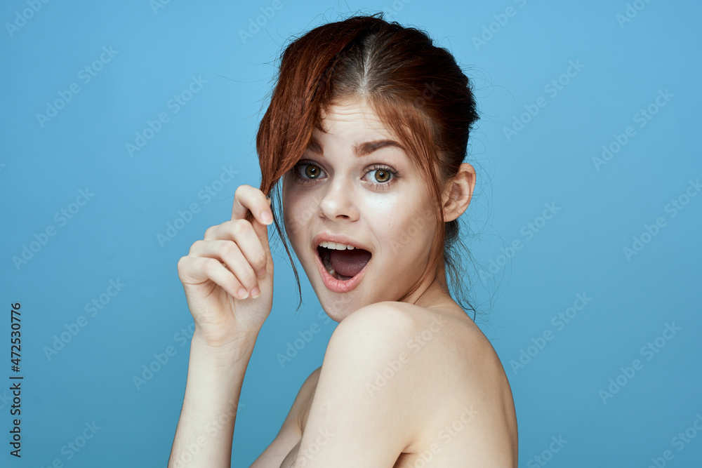 woman with bared shoulders pigtail emotions posing blue background woman with bared shoulders pigtail emotions posing blue background