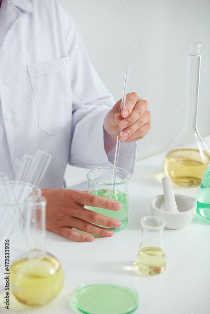 Scientist research with petri dish and a white background in laboratory , color liquid in a test tube and scientist for cosmetic advertising , photography science concept Scientist research with petri dish and a white background in laboratory , color liquid in a test tube and scientist for cosmetic advertising , photography science concept