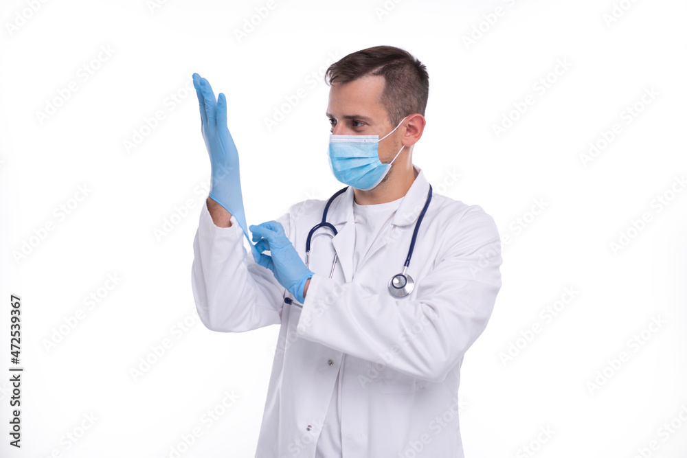 Doctor Puts on Gloves and Wearing Medical Mask Isolated. Man Doctor Protection Mask Workwear. Medical Concept Corona Virus. Doctor Puts on Gloves and Wearing Medical Mask Isolated. Man Doctor Protection Mask Workwear. Medical Concept Corona Virus.