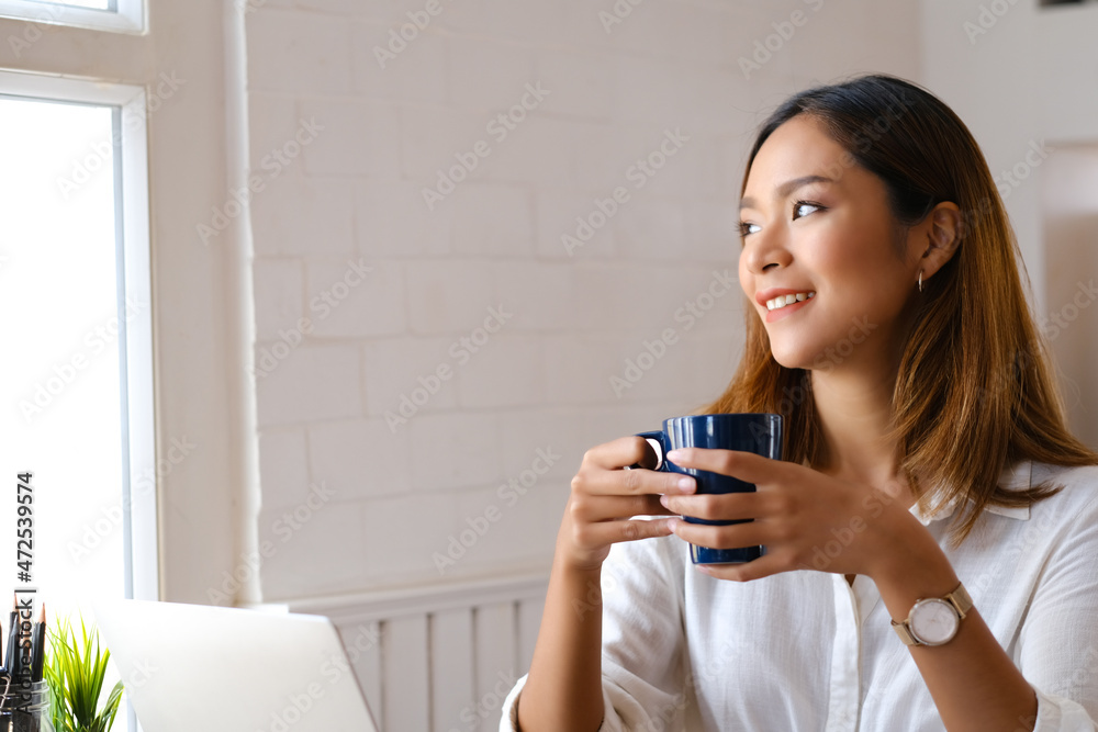 Beautiful woman using laptop at cafe while drinking coffee. Beautiful woman using laptop at cafe while drinking coffee.