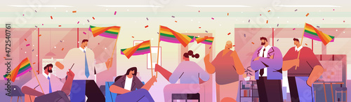 mix race businesspeople holding lgbt rainbow flags gay lesbian love parade pride festival transgender love concept