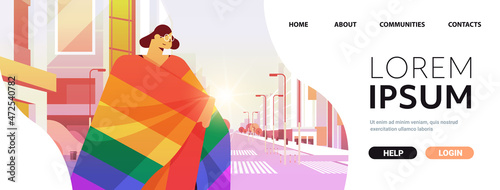 woman with lgbt rainbow flag walking on city street gay lesbian love parade pride festival transgender love concept