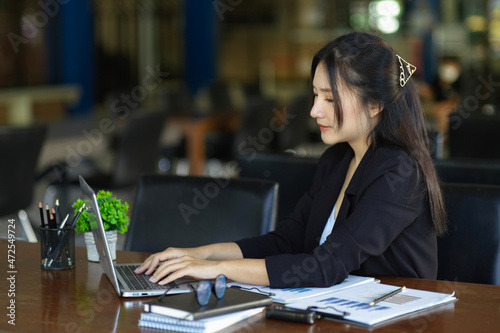 Attractive young assistant working on laptop computer