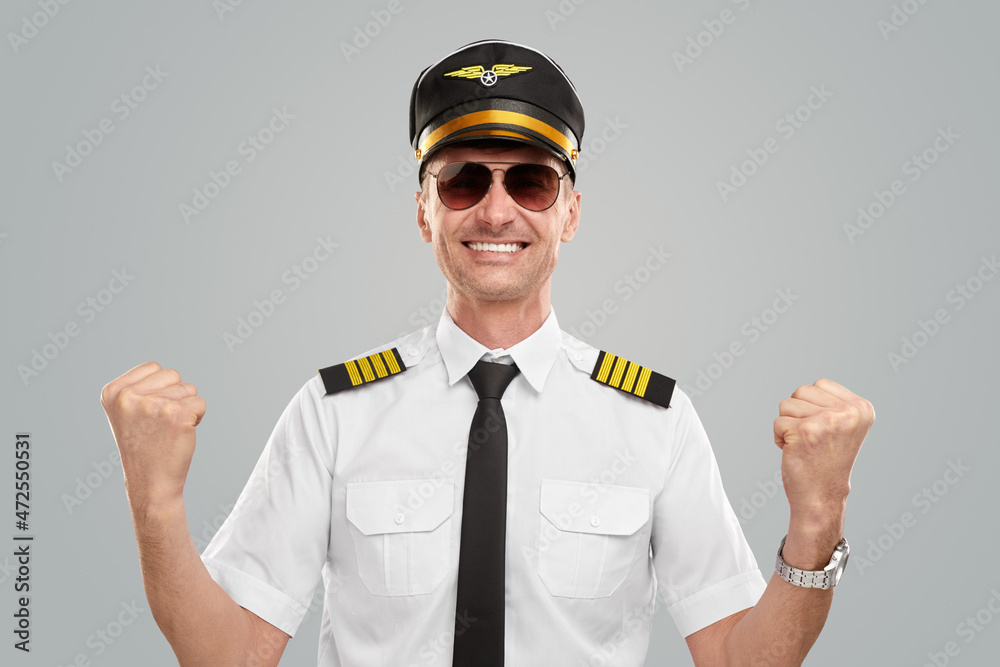 Happy male aviator making yes gesture and smiling Happy male aviator making yes gesture and smiling
