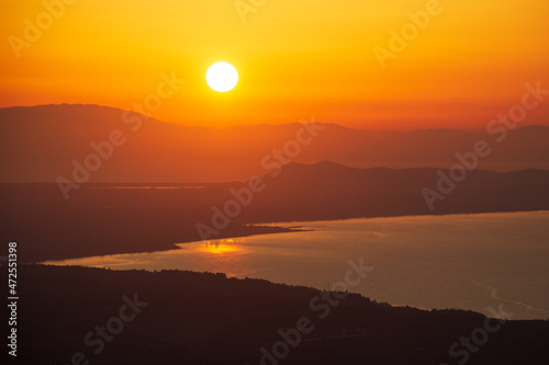 orange sunset over the sea and mountains © Юрий Надёжин